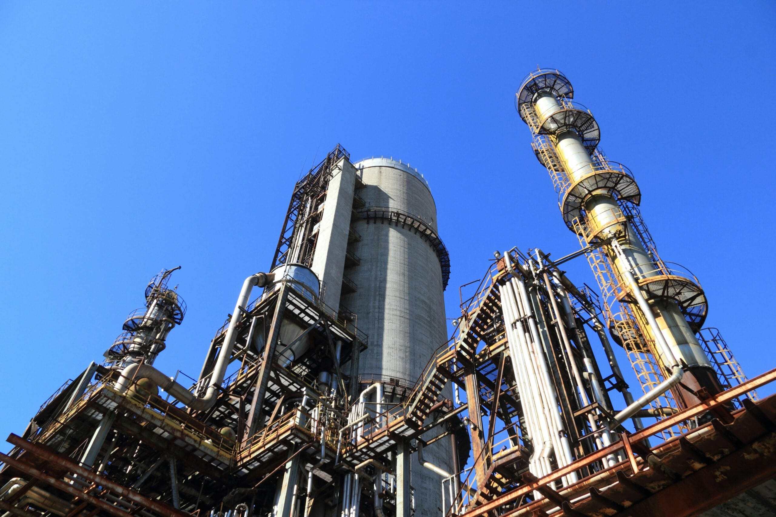View of industrial refinery structures highlighting property tax consulting for complex manufacturing facilities.